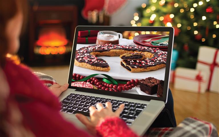 Plaid holiday box with two Kringle surrounded by holiday 