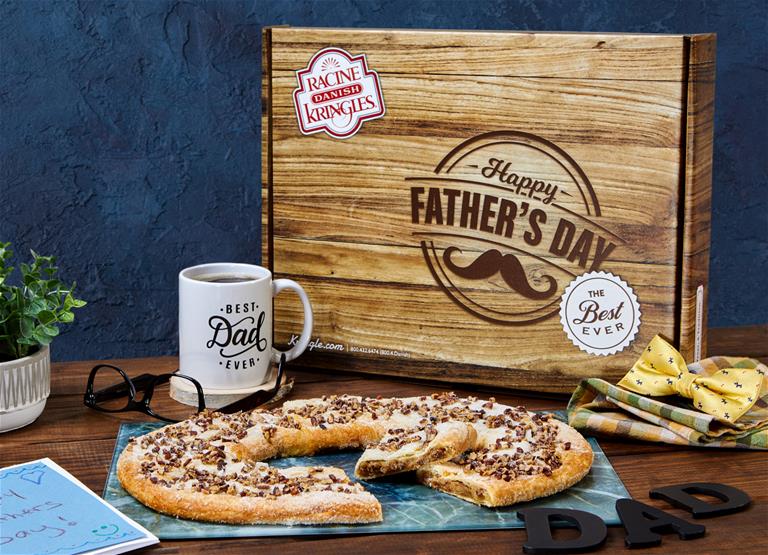 Father's Day box surrounded by Bourbon Pecan Kringle, coffee mug and glasses.
