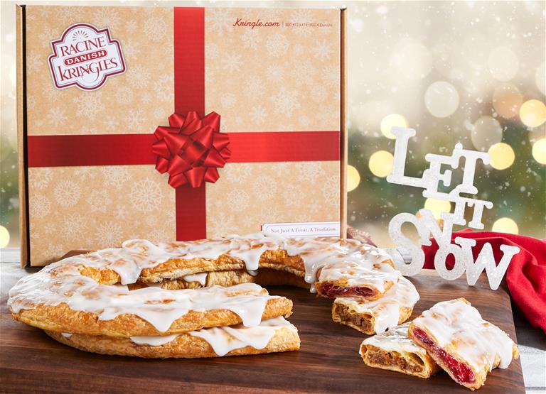 Holiday Kringle boxes surrounded by Kringle and holiday decorations. 