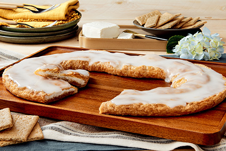 Cheesecake Kringle on white plate with slices cut out. 