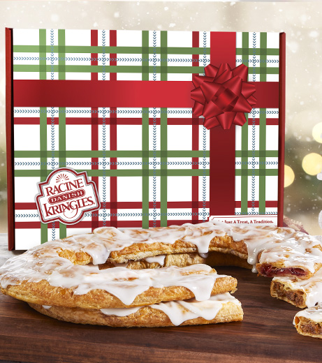 Holiday Gift box with red bow in artwork with raspberry and pecan Kringle in front on plate