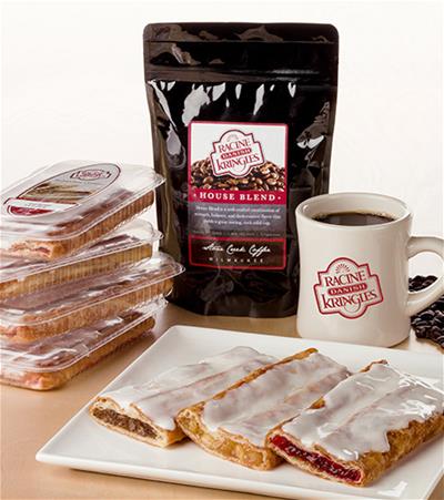 Slices of kringle on white plate with bag of coffee, single-served packaging and coffee mug.