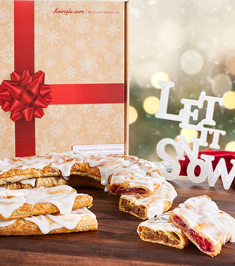 Holiday Gift box with red bow in artwork with raspberry and pecan Kringle in front on plate