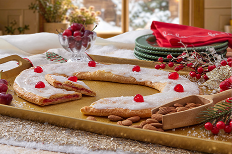 Cherry Almond Kringle on a gold plate with almonds