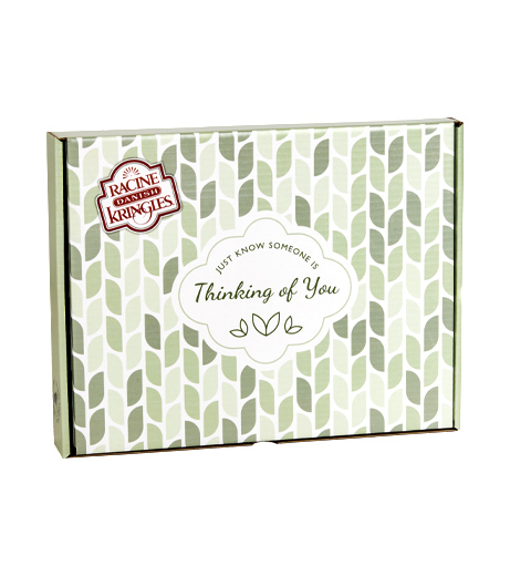 Green box with Thinking of You type with one Kringle in front flowers and cutlery