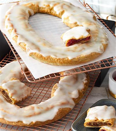 This bestseller contains an authentic Pecan Kringle and our classic Raspberry Kringle each wrapped in traditional flaky pastry and topped with smooth vanilla icing. Pecan Kringle is filled with fancy pecans, brown sugar, and cinnamon. The Raspberry Kringle is filled with slightly tart, handpicked raspberries. You can&rsquo;t go wrong giving this gift!

