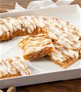 Gingerbread Kringle on white plate with chestnuts, cinnamon and pine branch on the side. 