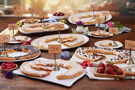 Pecan and Raspberry Kringle with a calendar in the background. 