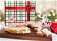 Holiday Gift box with red bow in artwork with raspberry and pecan Kringle in front on plate