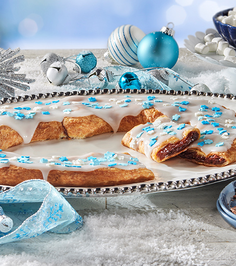 Winter Wonderland kringle on an oval plate surrounded by holiday decor.