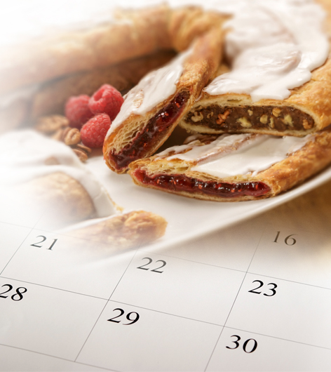 Pecan and Raspberry Kringle with a calendar in the background. 